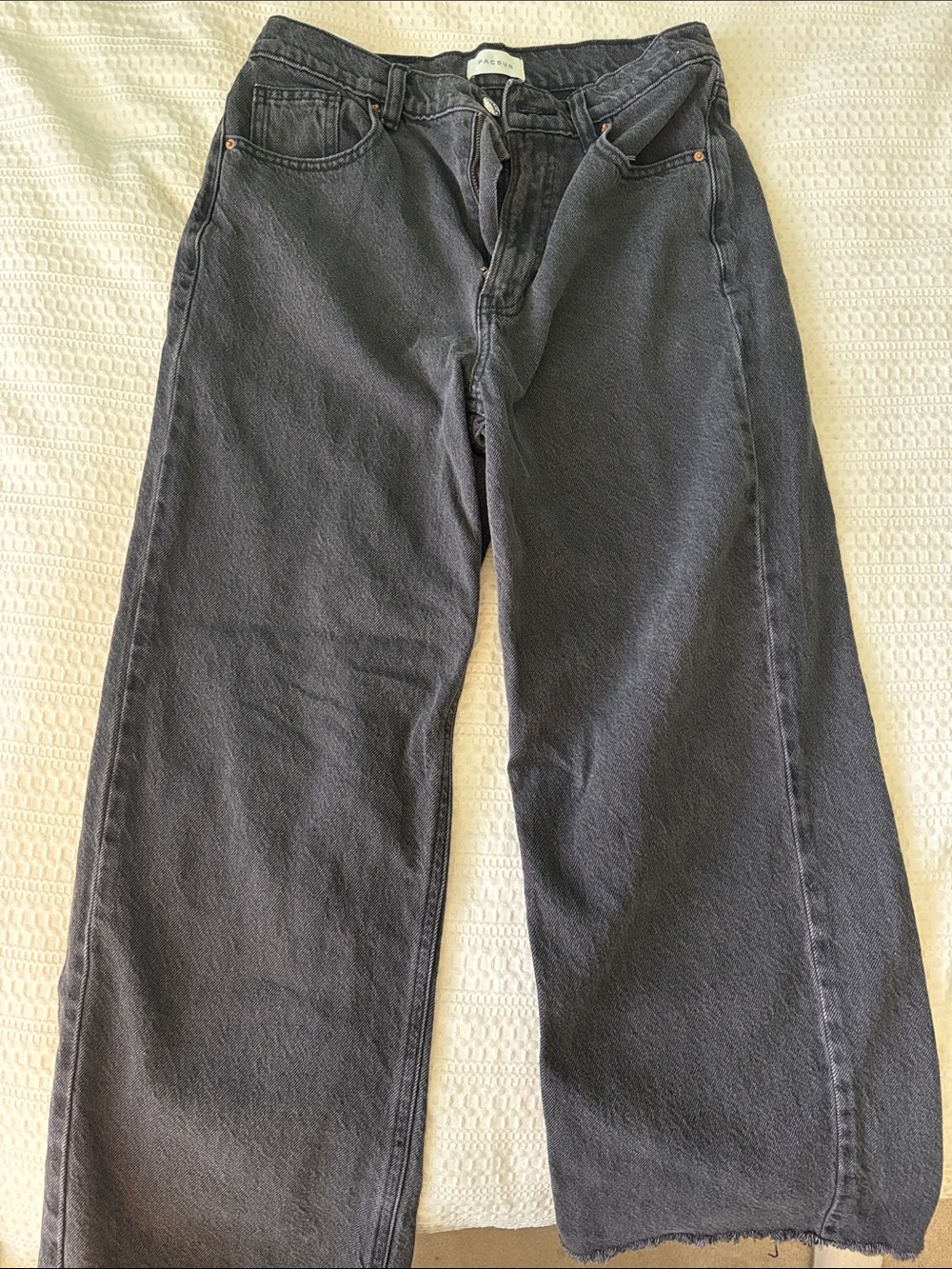 PacSun Women's Relaxed Wide-Leg Black Jeans with distressed bottom.